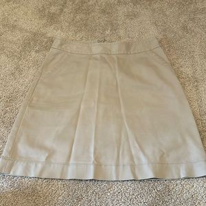 Banana Republic brand, women’s tan colored skirt with zipper in the back.